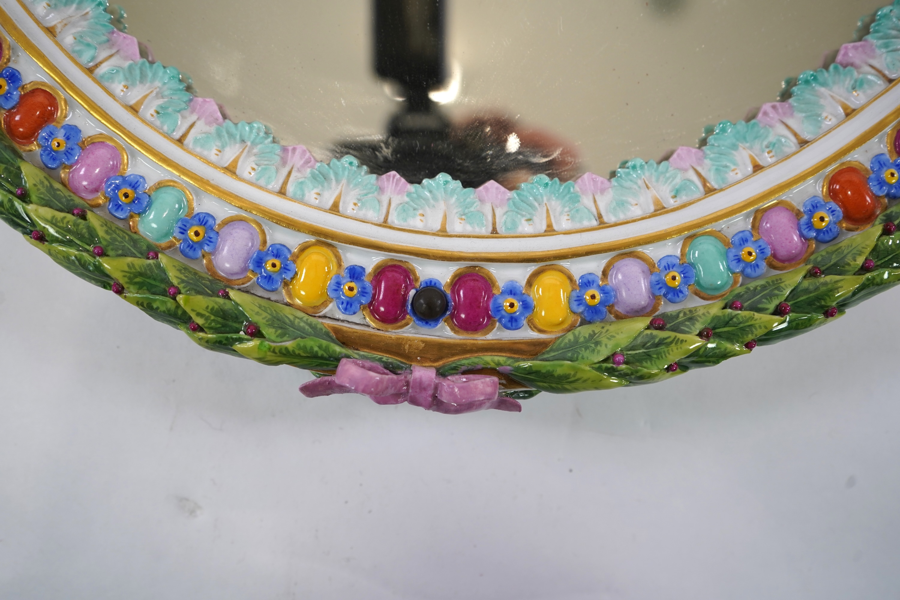 A Meissen figural oval mirror, late 19th century